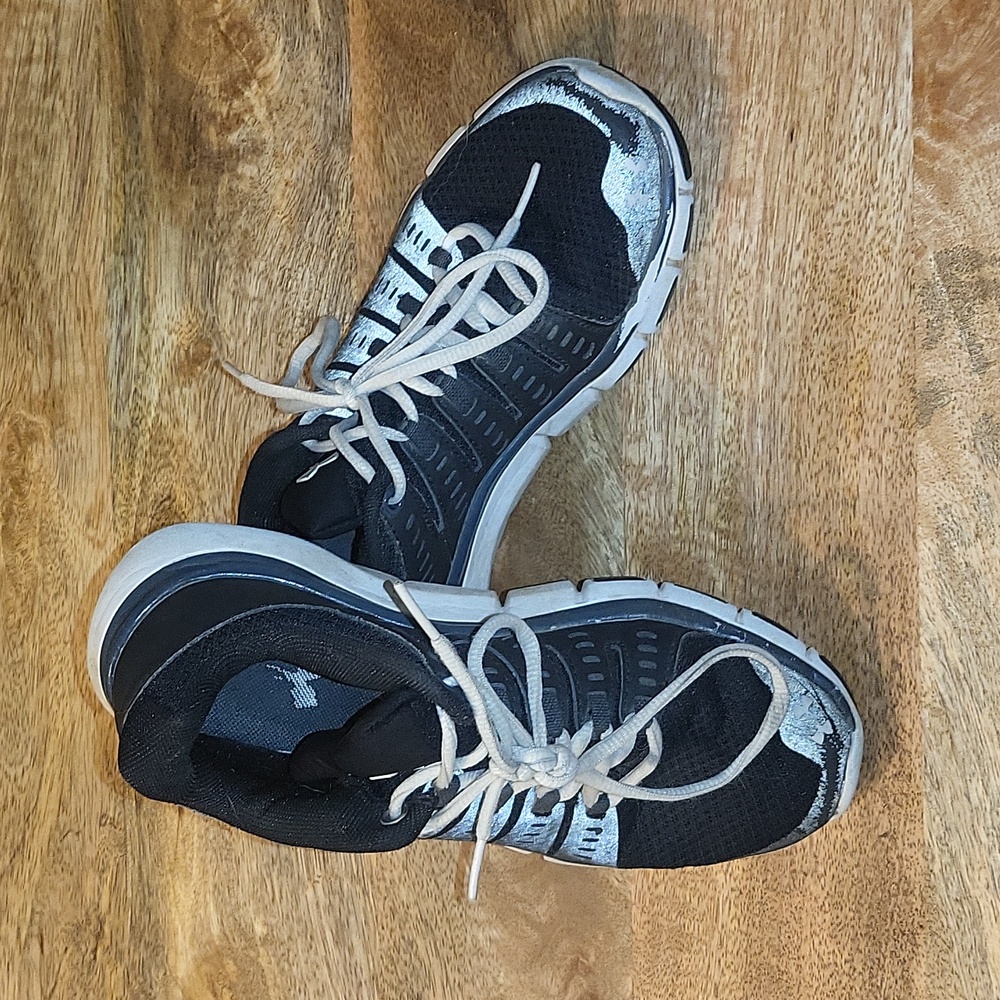 Black and white Under Armour kicks